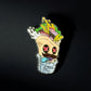 The Burrito Ball Marker by Crown Golf Designs features a vibrant cartoon burrito with red Xs for eyes, spilling tasty fillings and hot sauce, set against a plain black background.