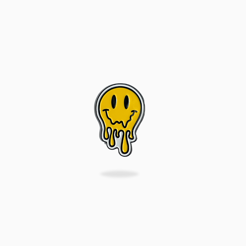 The Drip Smiley Ball Marker by Pin Creatures features a yellow smiley face with black eyes and a melting effect, centered on a white background—an ideal way to add playful style to your golf accessories.
