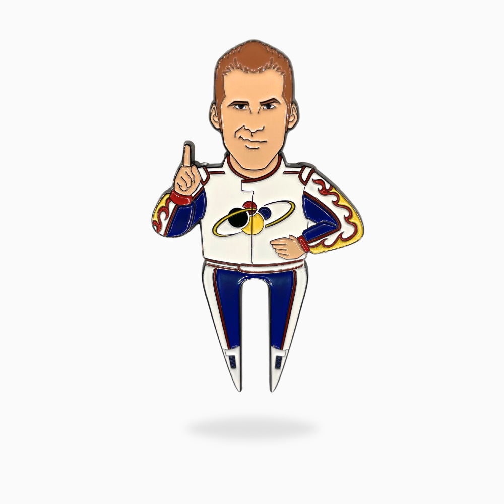 The Ricky Bobby Divot Tool by Pin Creatures is an enamel pin of a cartoon man in a white suit with blue, red, yellow, and black propeller details—great for golf fans or as a unique ball marker.