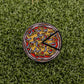 The Logie Joe's Golf Mexican Pizza "Slice" Premium Ball Marker, featuring colorful toppings and two removable slices, rests on green artificial grass.