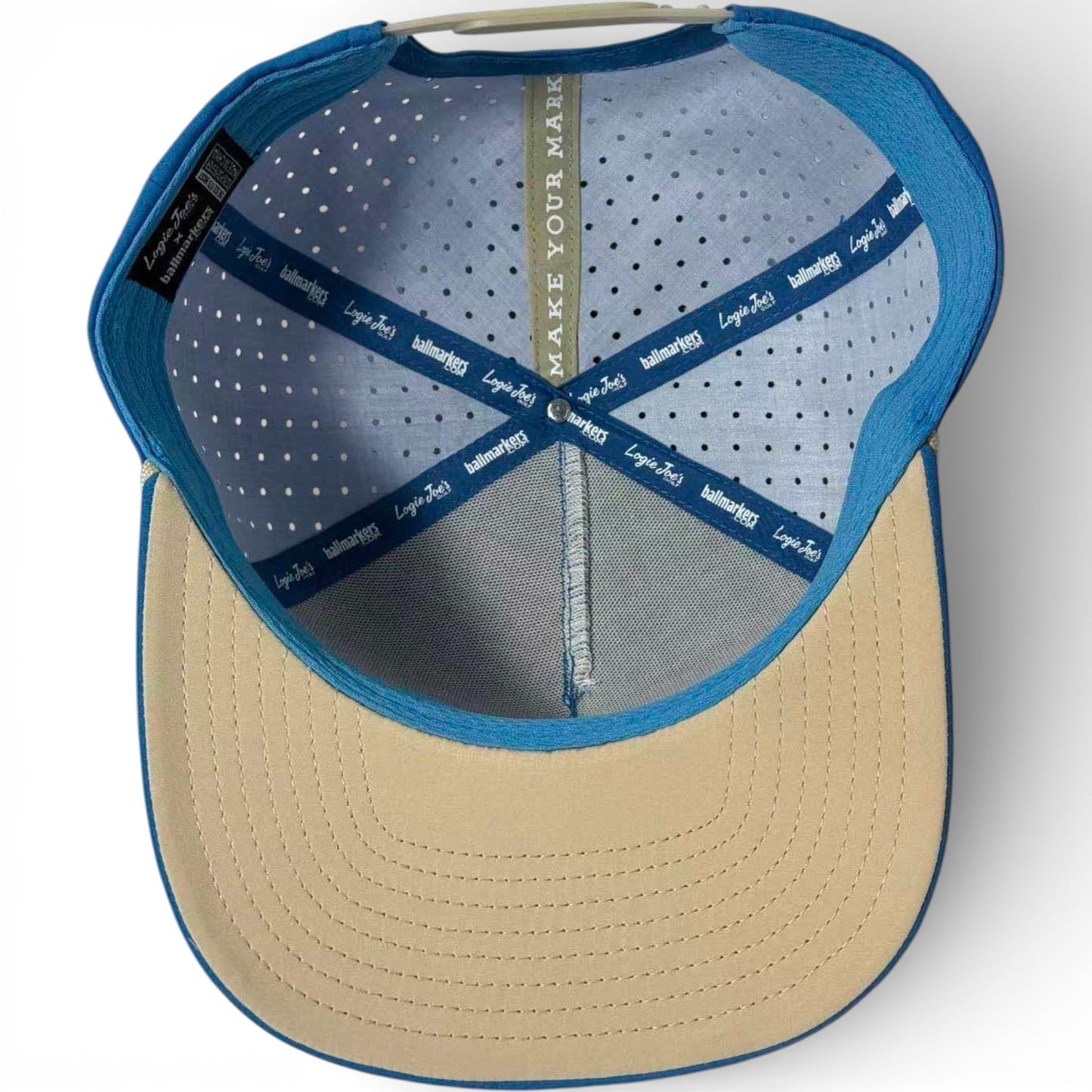 Interior view of Logie Joe's Golf Fairway Palms Golf Hat | Snapback Cap shows sweatband, ventilation holes, fabric strip with “MAKE YOUR MARK” inside the crown, and built-in magnetic ball marker holder with marker included. Adjustable, one size.
