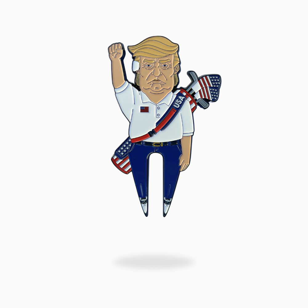 Show your patriotism with the Pin Creatures TRUMP Divot Tool—a cartoon-style pin of a blond man in a USA sash, holding an American flag axe. Perfect as a golf ball marker or with your magnetic hat clip.