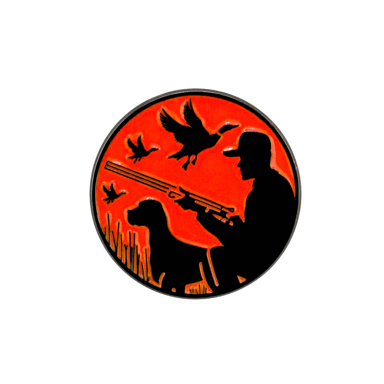 The Duck Hunter Ball Marker by Logie Joe's Golf features a circular design with a hunter and dog silhouette, orange background, and flying ducks.