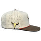 Logie Joe's Golf Longhorn Golf Hat: adjustable beige snapback with brown brim, side ventilation holes, embroidered tan bull skull on the side, built-in magnetic ball marker holder (marker included), and a small red accent above the brim.