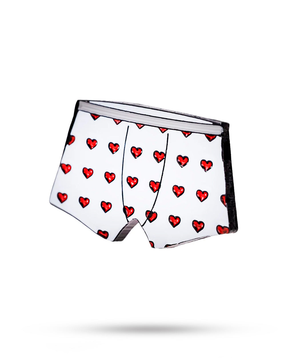 Heart Boxers Ball Marker by Pins and Aces floats against a plain white background, showcasing its playful red heart and black outline pattern with a subtle shadow beneath.