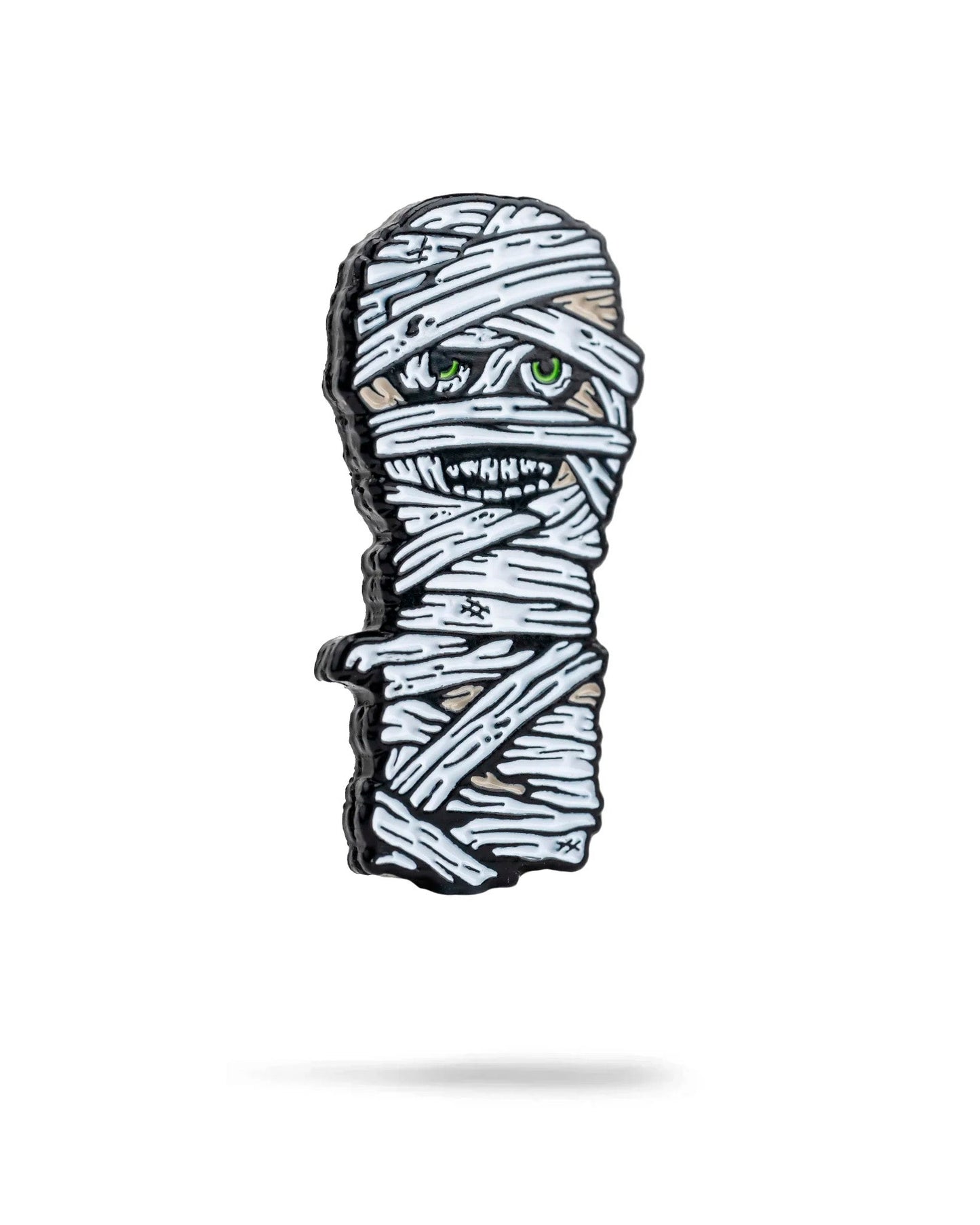 The Pins and Aces Mummy Ball Marker features a cartoon-style mummy wrapped in white bandages with green eyes and sharp teeth, finished in enamel with a magnetic back—perfect for standing out on the golf course.