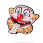 The Clowns Mouth Ball Marker by Pins and Aces features a colorful cartoon clown face with a red nose, big eyes, orange hair, and an open mouth with its tongue out on a white enamel background.