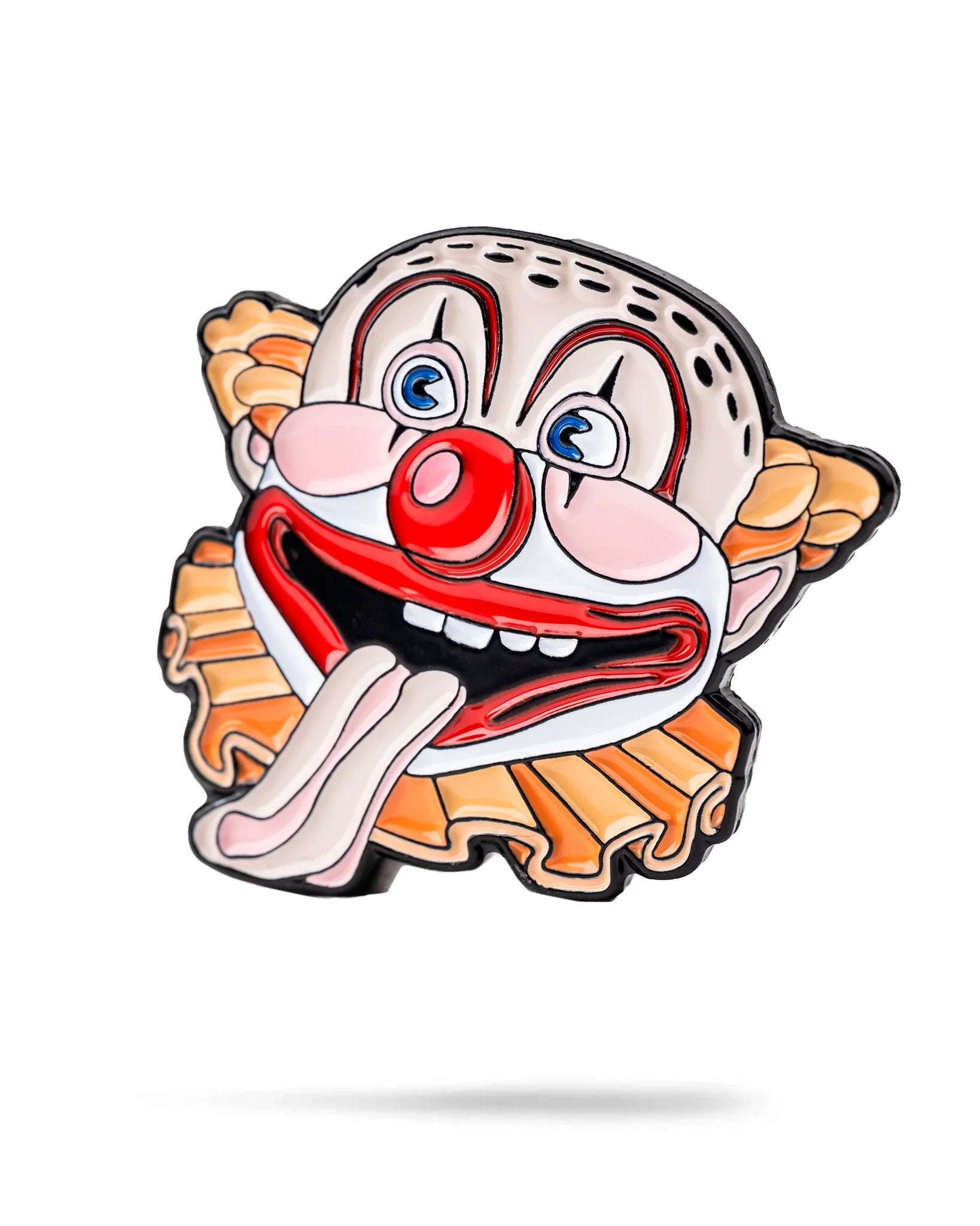 The Clowns Mouth Ball Marker by Pins and Aces features a colorful cartoon clown face with a red nose, big eyes, orange hair, and an open mouth with its tongue out on a white enamel background.