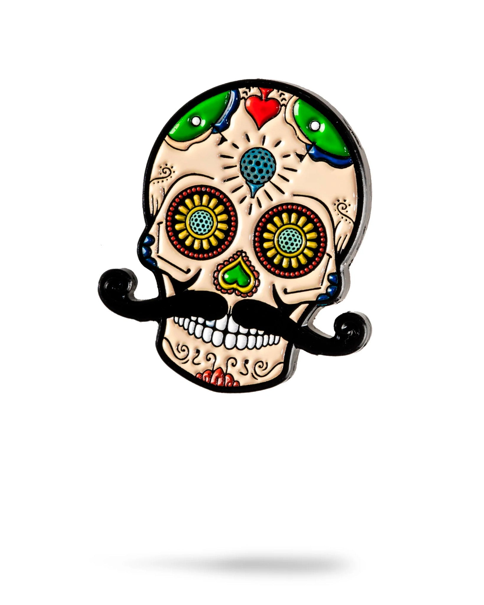 The Sugar Skull Ball Marker by Pins and Aces features vibrant colors, green and red hearts, spiraled eyes, and a bold black mustache, capturing Día de los Muertos style—ideal as an enamel or stainless steel marker on the green.