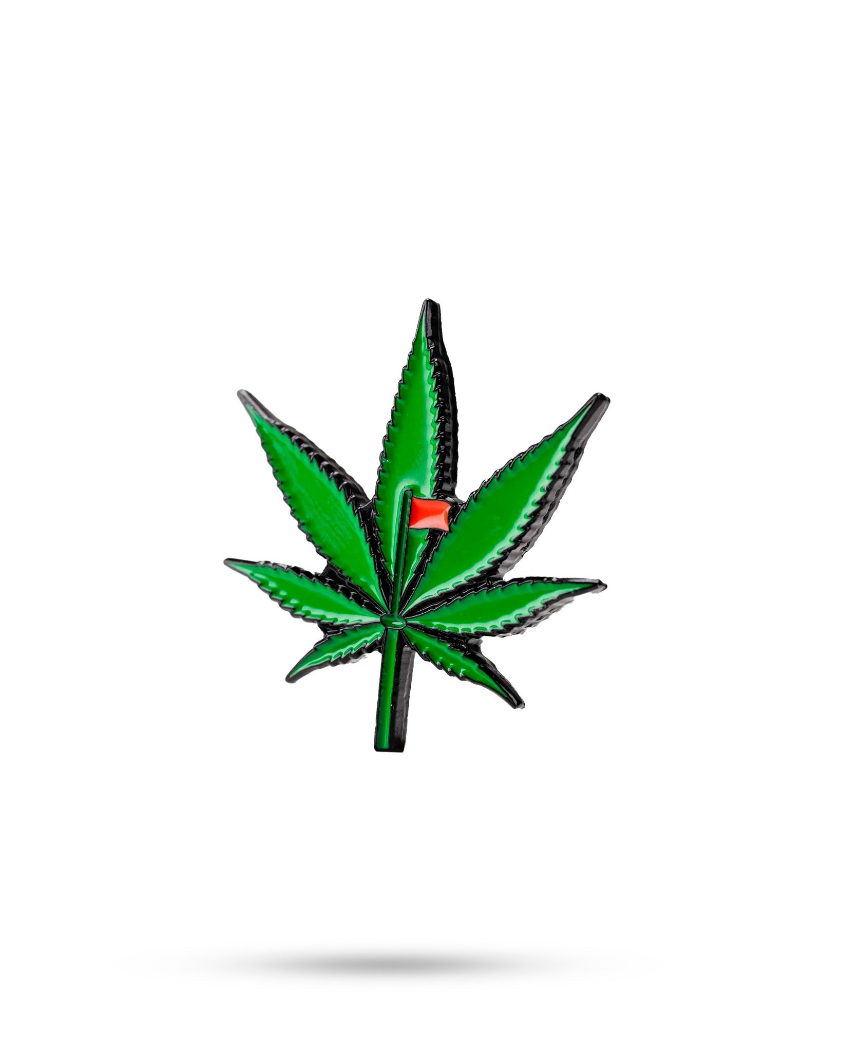 The Pot Leaf Ball Marker by Pins and Aces features a green cannabis leaf with a red flag on one leaflet, set against a white background with subtle shadow—ideal for magnetic ball markers or stainless steel accessories.