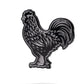 The Pins and Aces Black Cock Ball Marker is a black and silver enamel golf marker shaped like a rooster, displayed on a white background with a subtle shadow underneath.
