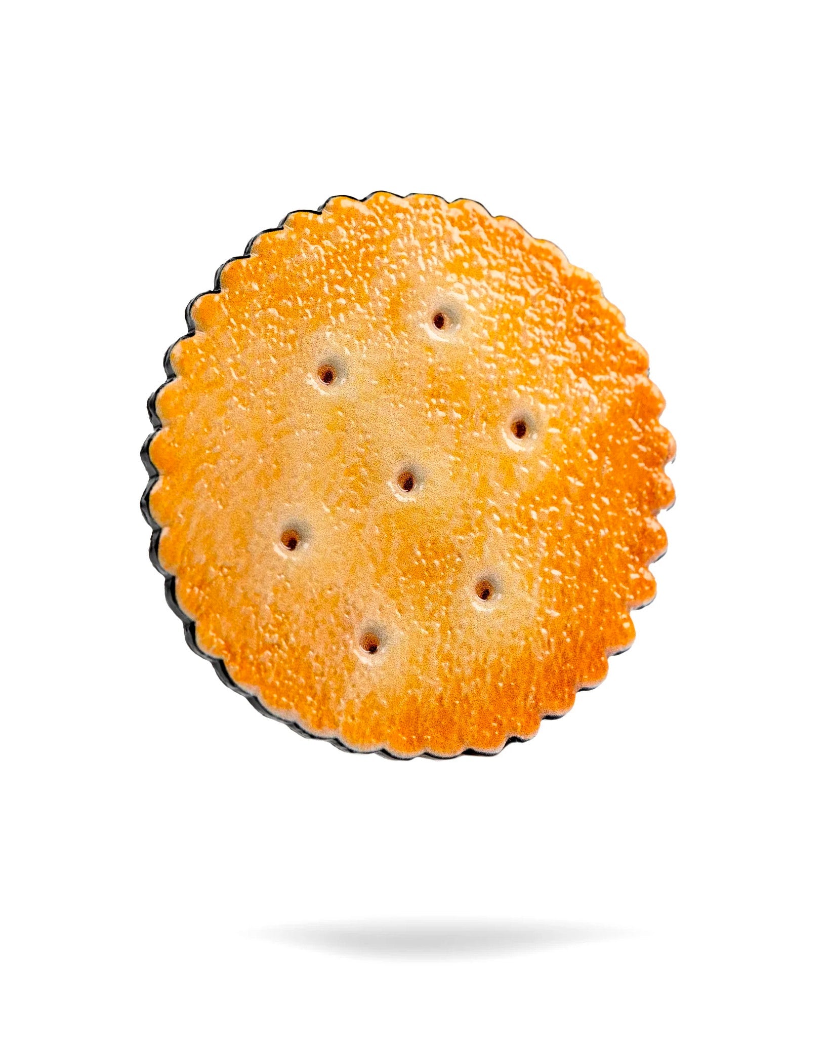 The Gilmore Cracker Ball Marker by Pins and Aces features a single round, golden-brown design with scalloped edges and seven holes, set against a white background with a faint shadow—its polished surface echoes classic golf ball markers.