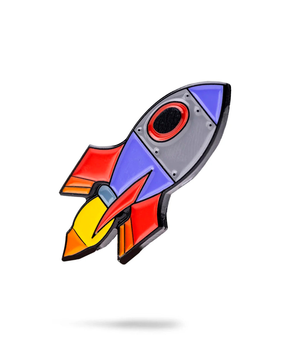 The Rocket Emoji Ball Marker by Pins and Aces is a vibrant enamel pin with red, yellow, purple, and blue accents and a black outline—perfect for golf lovers as both a unique accessory and functional ball marker.
