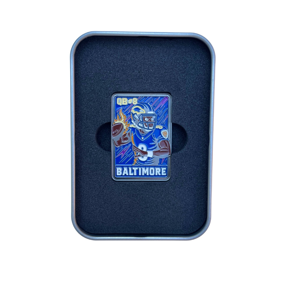 The Pin Creatures Baltimore Trading Card Ball Marker is a rectangular enamel pin in a foam-lined box showing a football player in blue gear, with "QB #8" on top and "BALTIMORE" below—a unique limited edition golf accessory.