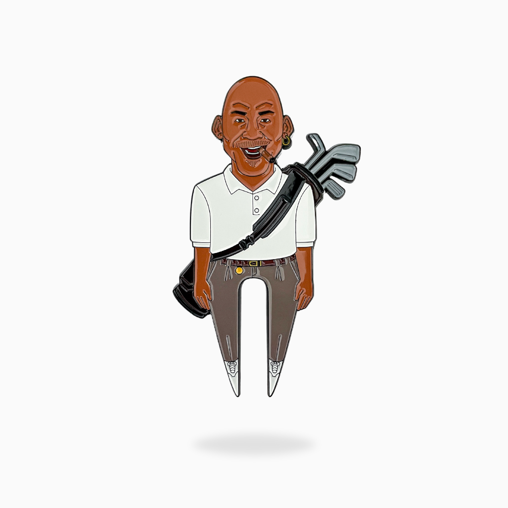 Cartoon-style illustration of The GOAT 23 by Pin Creatures: a smiling bald man with earrings in a white polo and brown pants, holding golf clubs and a ball marker over his shoulder against a plain white background.