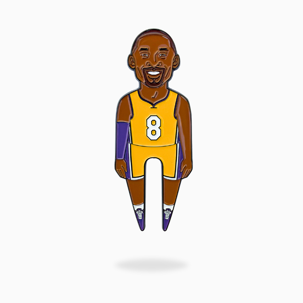 The MAMBA Divot Tool by Pin Creatures features a cartoon basketball player in a yellow #8 jersey with purple armband, making it a fun golf accessory or unique ball marker.