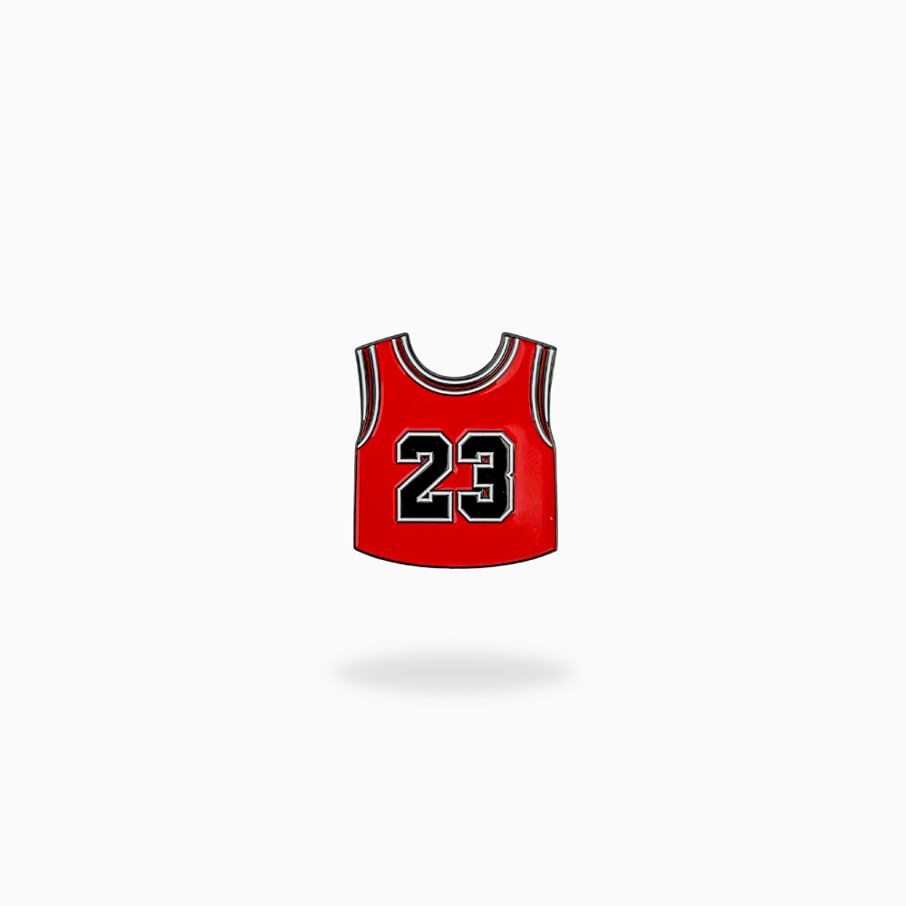 The GOAT 23 by Pin Creatures features a red jersey with black and white trim and bold "23" lettering, centered on a white background—ideal inspiration for your next unique ball marker or golf accessory design.