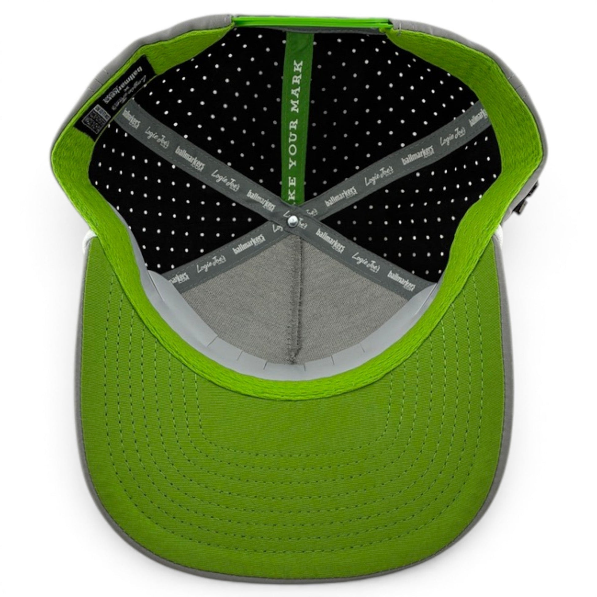 Top-down view of the Alien Caddy Golf Hat by Logie Joe's Golf, showing polka-dot lining, branded hatbands, magnetic ball marker holder (marker included), and "MAKE YOUR MARK" printed inside the adjustable snapback cap.