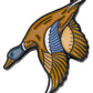 The Pins and Aces Flying Mallard Ball Marker features a vibrant duck with outstretched wings in brown, orange, blue, and white enamel.