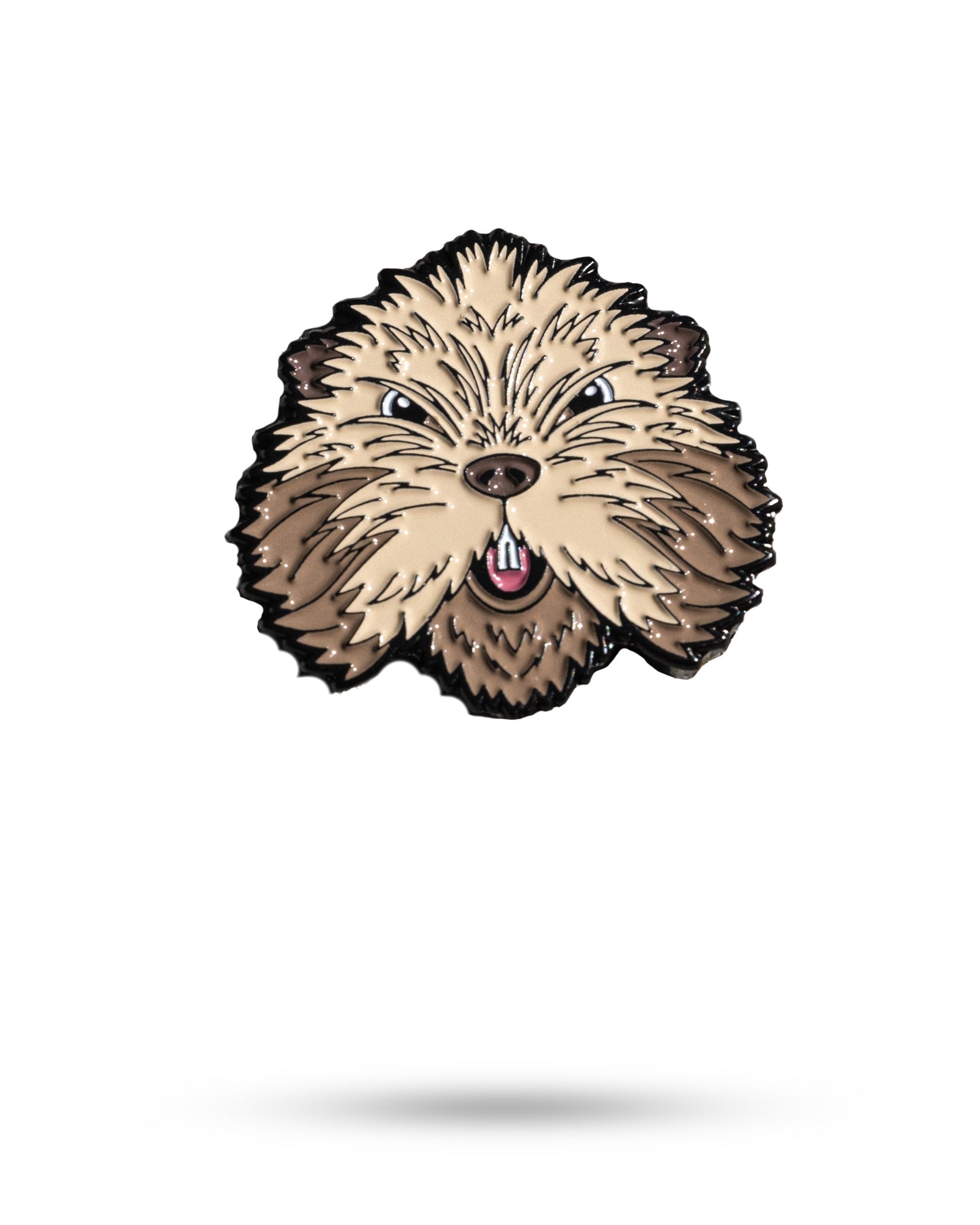 The Pins and Aces Gopher 2.0 Ball Marker is a metal enamel pin shaped like a fluffy dog's face, with beige and brown fur, pointed ears, and an open mouth with a pink tongue, crafted from cast stainless steel.