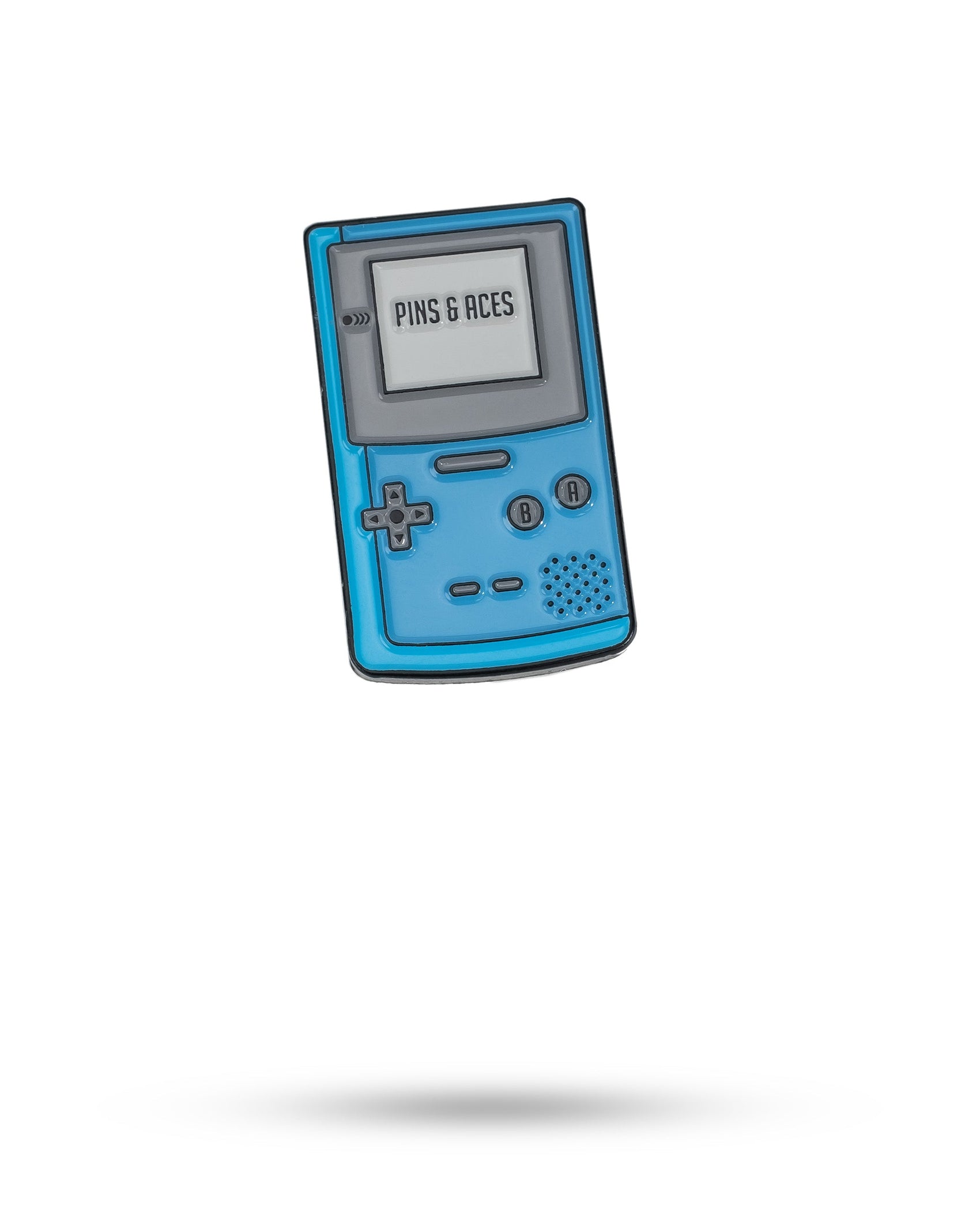 A blue handheld Game Boy Ball Marker by Pins and Aces, styled like a classic Game Boy with “PINS & ACES” on its screen, sits centered on a white background—a unique retro golf accessory.