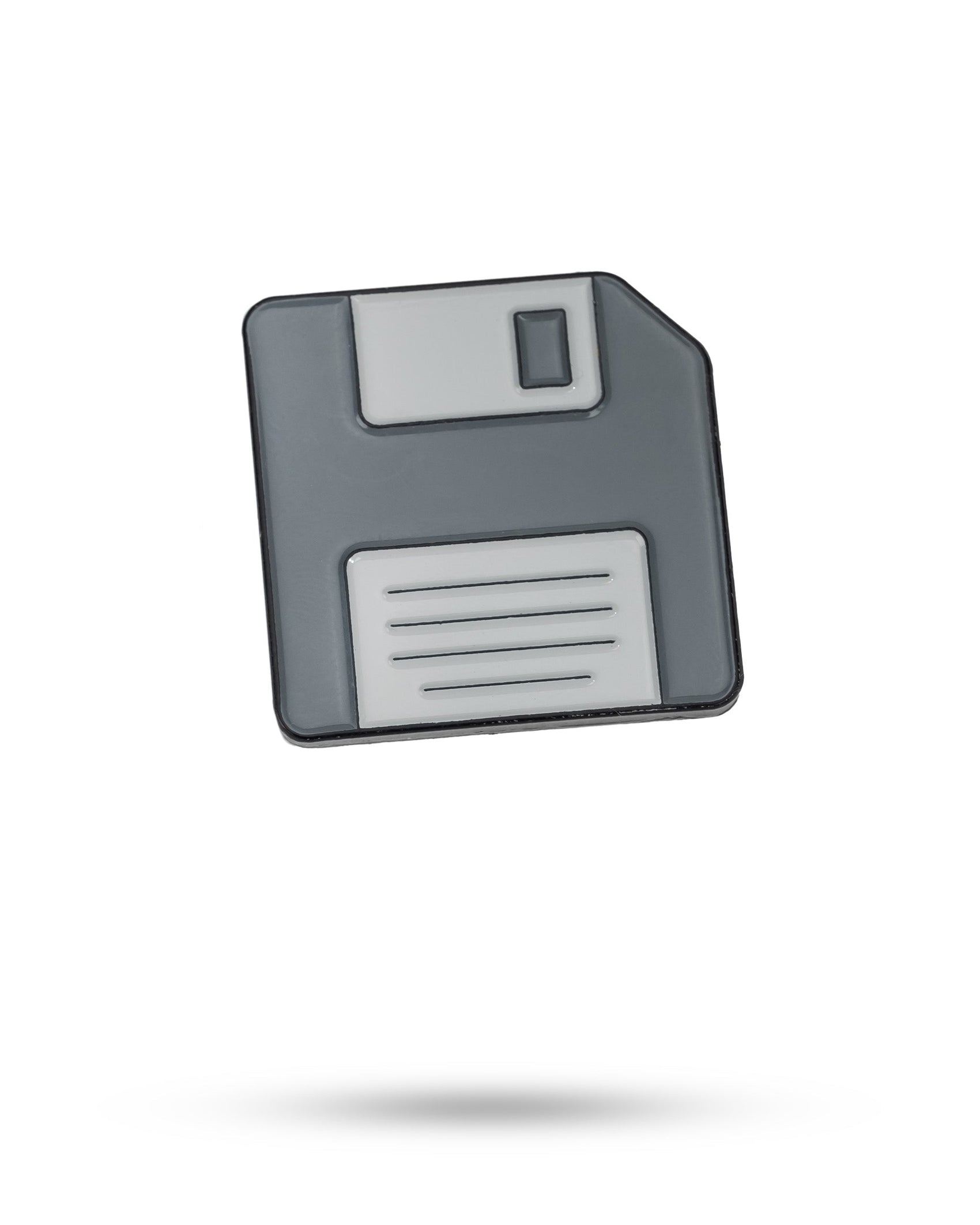 A grey and white Pins and Aces Floppy Disc Ball Marker icon appears on a white background, with a faint shadow beneath it.
