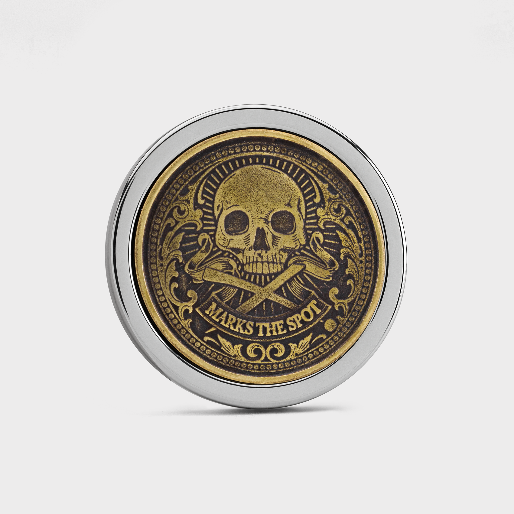 The Omen IV Antique by Doubloon is a round Tungsten doubloon with a gold skull and crossbones, intricate patterns, "MARKS THE SPOT" engraved below, and a silver rim, all set against a white background.