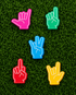The Foam Finger Ball Marker Bundle by Ballmarkers.com features five vibrant, hand-shaped markers with unique gestures on green grass—fun, playful accessories that add a unique touch to any golf game.