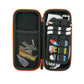 The Ballmarkers.com Accessory Case is an open black and orange zippered case featuring a mesh pocket with keys, a tube, golf ball markers, and a dropper on the left, plus stationery items, stickers, and a pencil secured by elastic bands on the right.