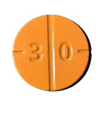An orange, round Addy Ball Marker from Golf Gear Heaven, featuring a vertical score line and the number 30 embossed on one side—resembling a tiny golf ball accessory.