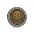 The Omen I by Doubloon is a gold and black titanium coin with an ornate skull and crossbones centerpiece, decorative patterns, and a “MARKS THE SPOT” banner, capturing the style of a classic doubloon.