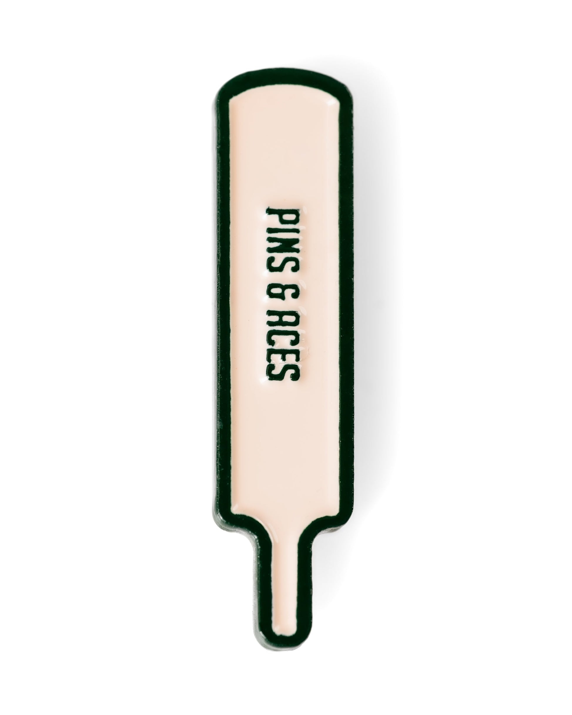 The Quiet Please - Ball Marker by Pins and Aces is a cream cricket bat-shaped pin with a black outline, vertical "PINS & ACES" text, and a magnetic backing for premium feel.