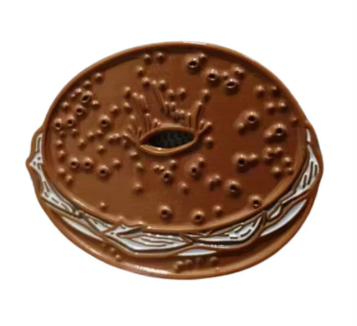 A bagel-and-cream-cheese-themed ball marker by Golf Gear Heaven, designed to resemble a round, textured baked treat—perfect for marking your spot on the green after a great shot while showing off your love for breakfast classics.