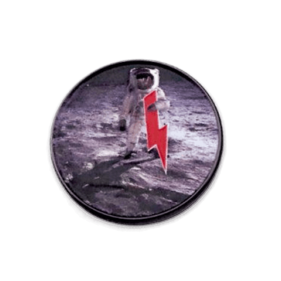 The Byrd, LLC's BYRD BALL MARKERS - Merica is a circular pin with an astronaut on the moon and a red lightning bolt—an out-of-this-world pick for magnetic golf accessories or golf ball markers.