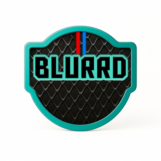 A badge with a teal border features “THE BLURRD PREMIUM BALL MARKER” in bold, teal letters on a black, diamond-patterned background. A small red and blue stripe tops the text, making this BLURRD accessory a magnetic golf ball marker standout.