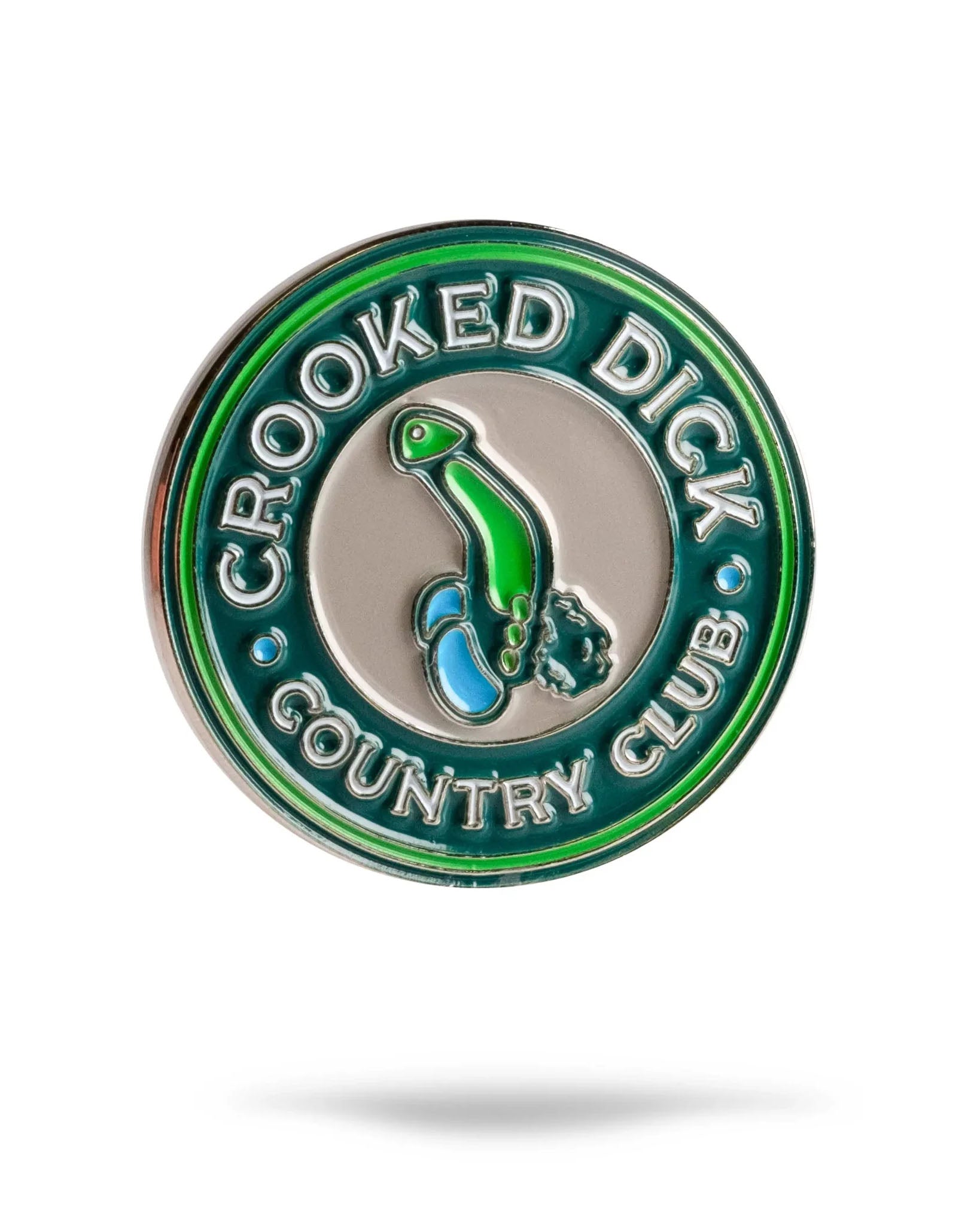 The Crooked Dick CC Ball Marker by Pins and Aces is a round green and silver premium golf marker featuring “CROOKED DICK COUNTRY CLUB” and a whimsical blue-and-green enamel illustration at its center.