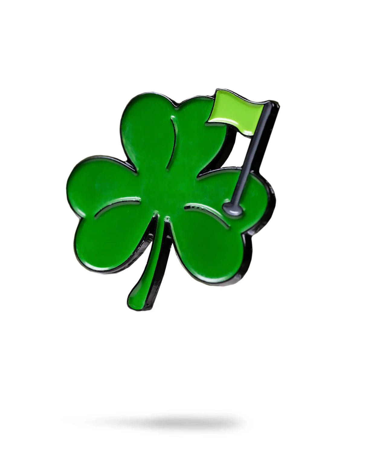 The Shamrock Ball Marker by Pins and Aces is a shiny green enamel four-leaf clover pin featuring a small green golf flag on one leaf, shown isolated on a white background with a faint shadow underneath.