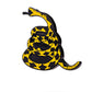 The Don't Tread on Me Ball Marker by Pins and Aces features a black and yellow coiled snake, mouth open and ready to strike, on a white background—ideal for any magnetic surface or stainless steel accessory.