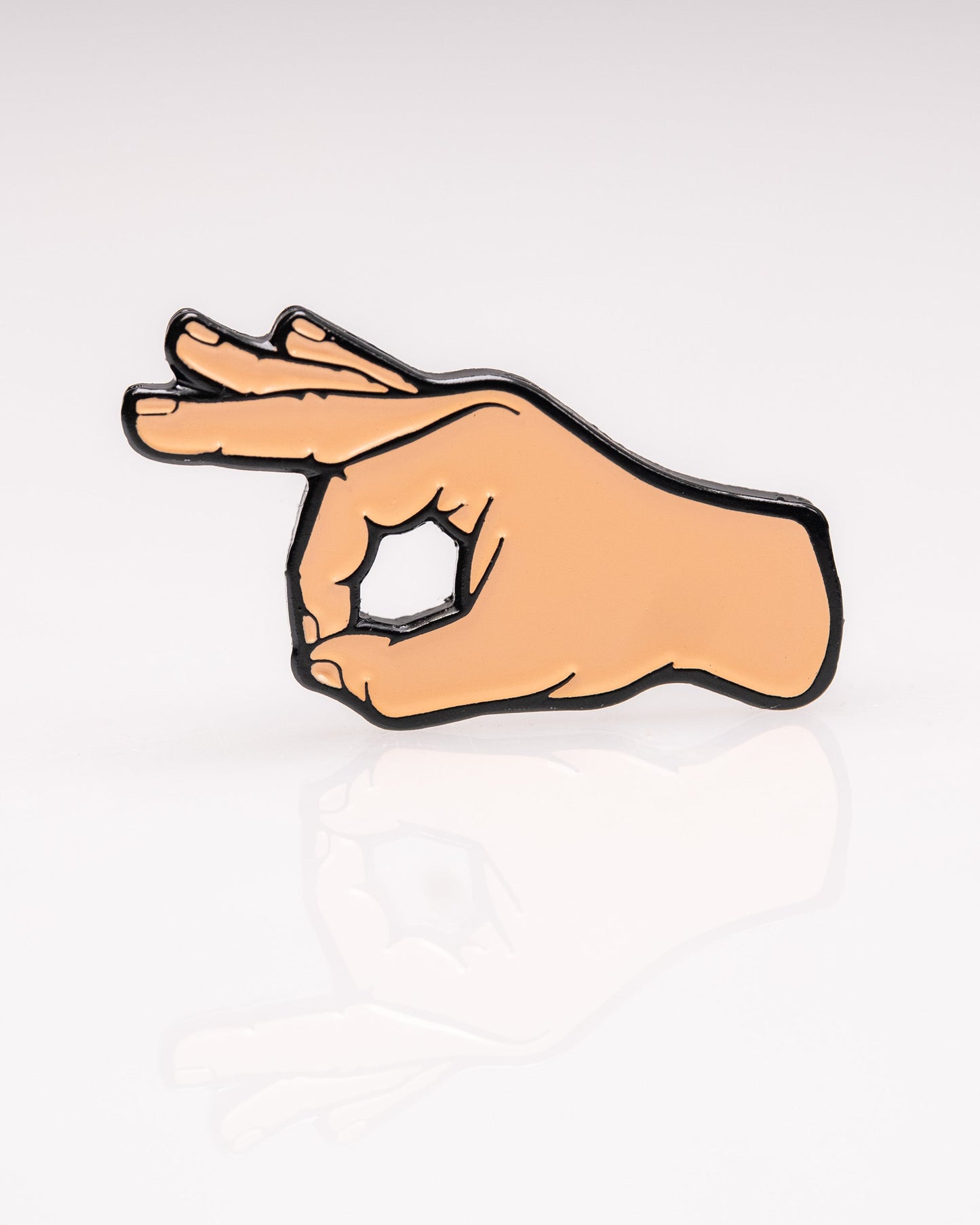 The OK Hand Ball Marker by Pins and Aces is an enamel golf accessory shaped like a hand making the OK gesture, shown on a white background with a subtle reflection.