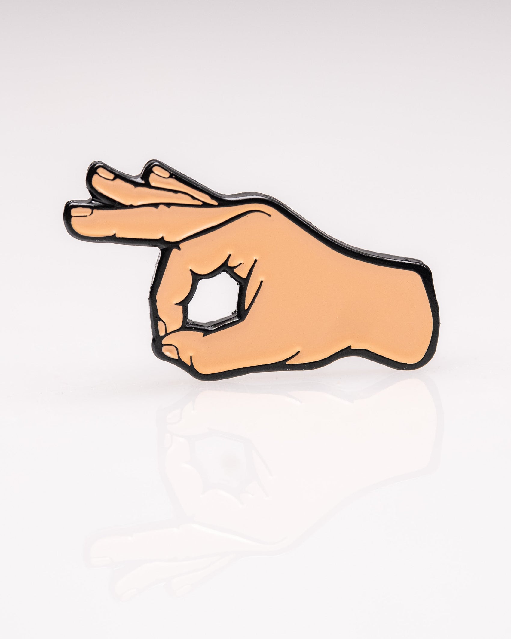 The OK Hand Ball Marker by Pins and Aces is an enamel golf accessory shaped like a hand making the OK gesture, shown on a white background with a subtle reflection.