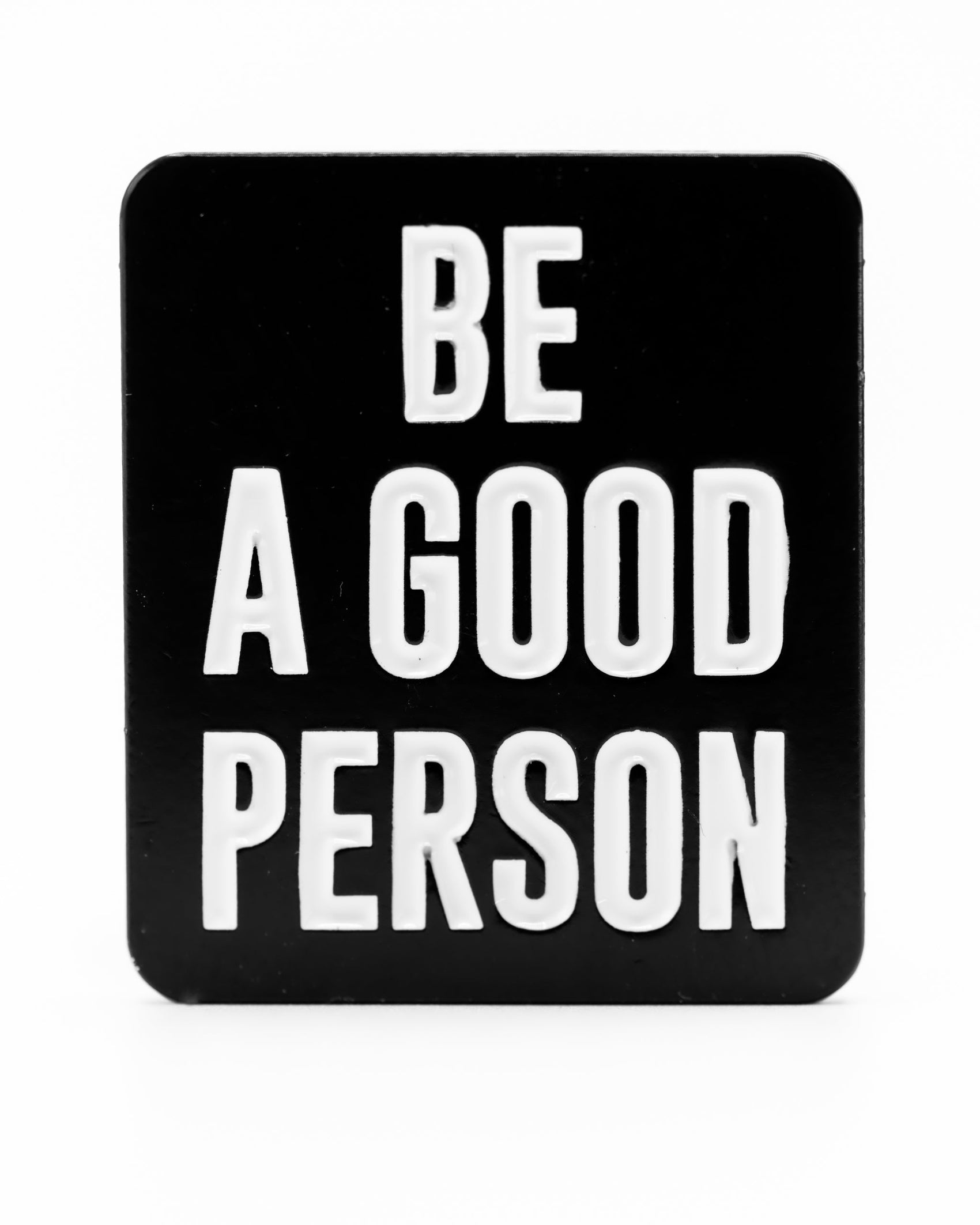 The Be A Good Person - Ball Marker by Pins and Aces features bold white letters on a black background, displaying the inspiring message: BE A GOOD PERSON, in the signature Pins and Aces style.