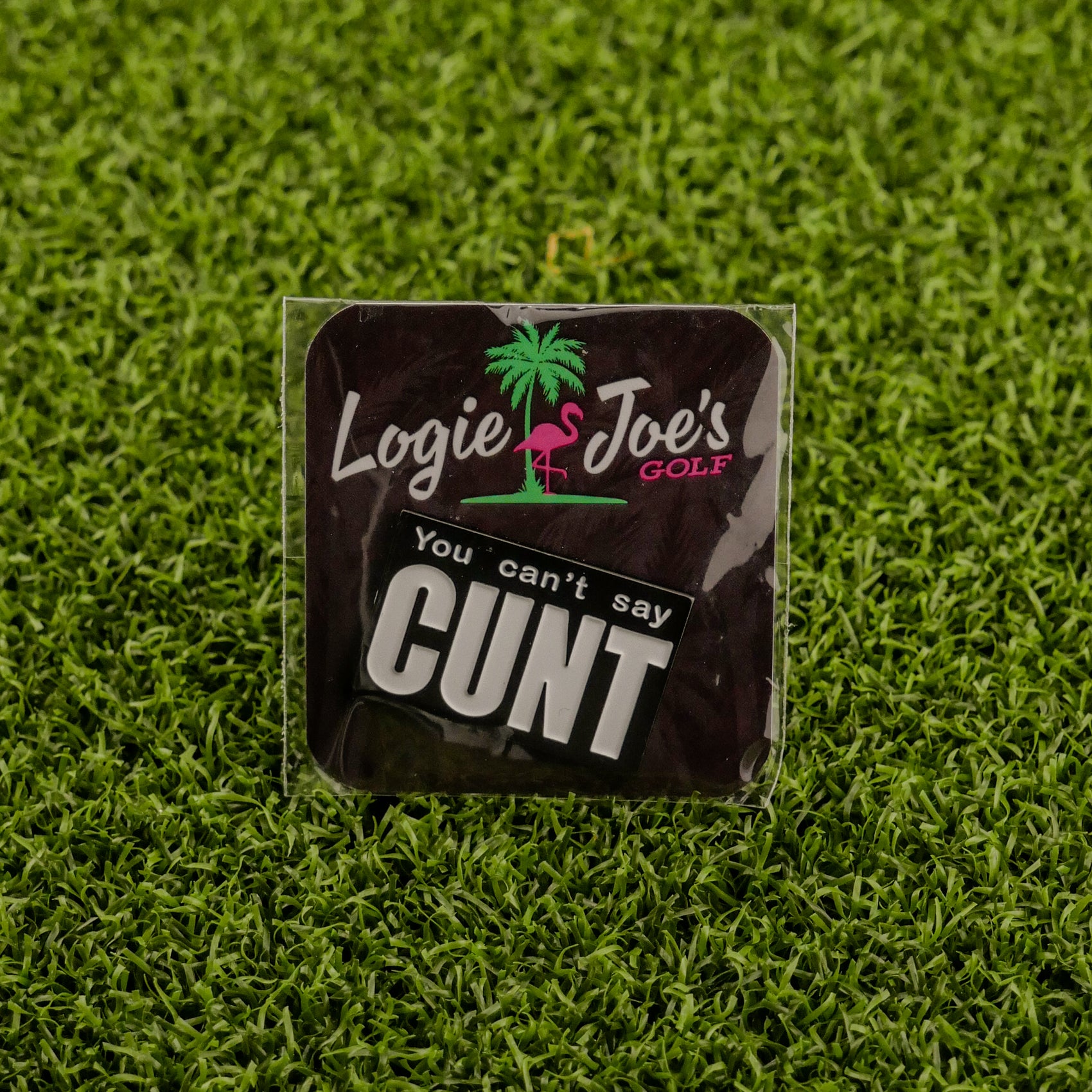 A humorous ball marker from Ballmarkers by Logie Joes features a palm tree, flamingo, and boldly says You Can’t Say Cunt—perfect for golfers who appreciate unique golf accessories.