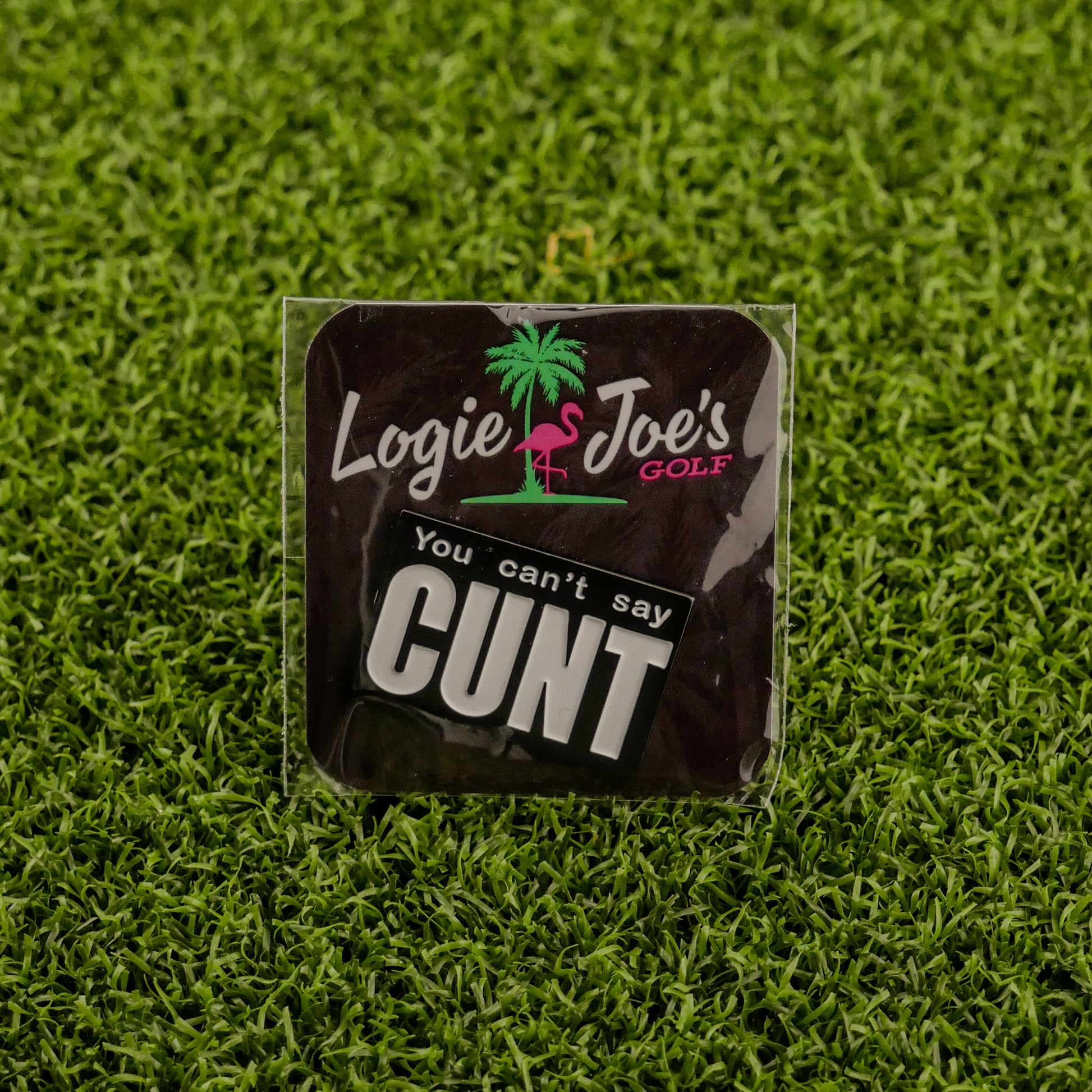 A humorous ball marker from Ballmarkers by Logie Joes features a palm tree, flamingo, and boldly says You Can’t Say Cunt—perfect for golfers who appreciate unique golf accessories.