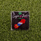 The Cock Rocket by Logie Joe's Golf is a vibrant rocket-shaped divot tool in branded packaging on green artificial grass—a fun and playful accessory for your collection of novelty golf gear.