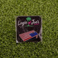 A Corn Hole Board from Logie Joe’s Golf sits on artificial green grass—one of the premium golf accessories that also makes for funny golf gifts.