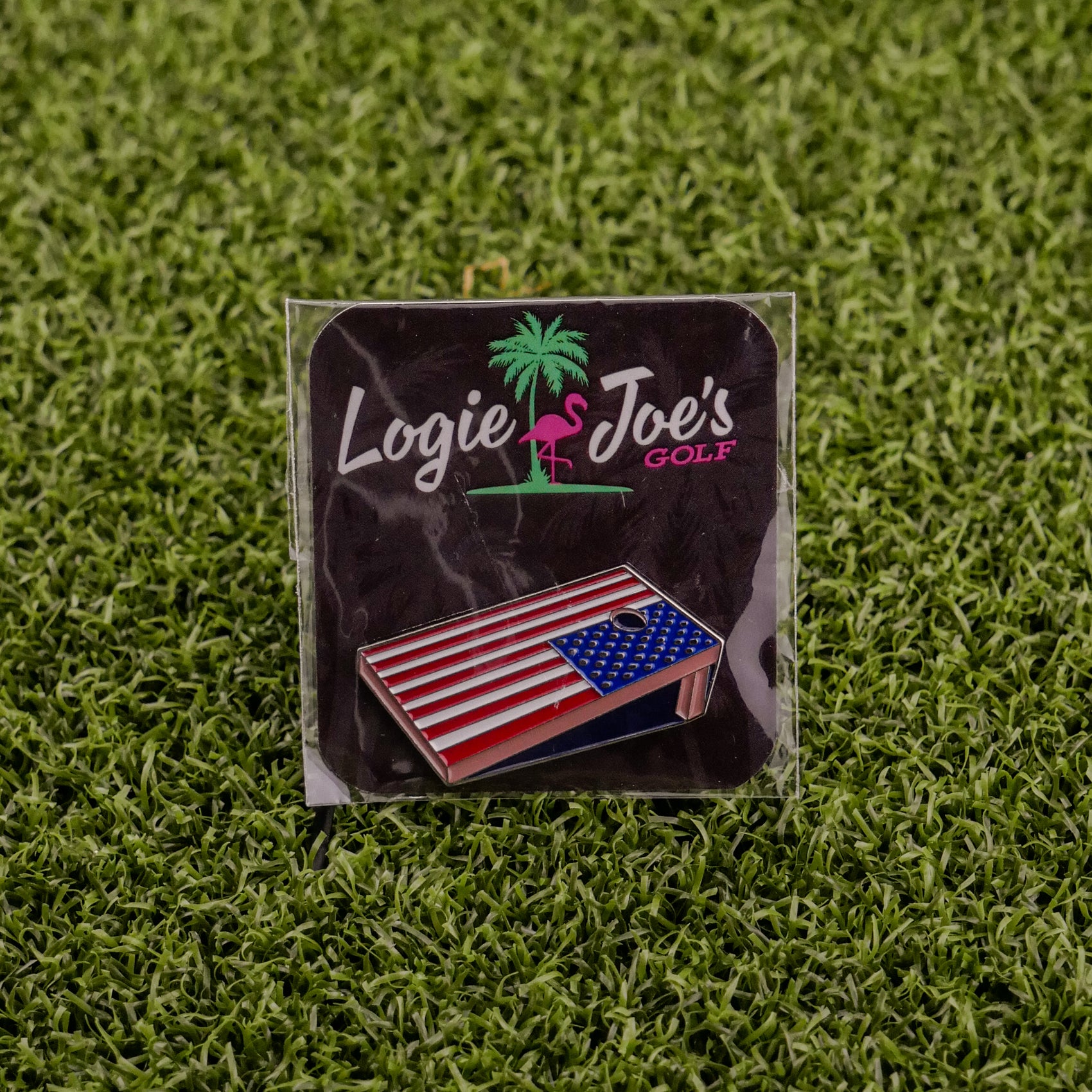 A Corn Hole Board from Logie Joe’s Golf sits on artificial green grass—one of the premium golf accessories that also makes for funny golf gifts.