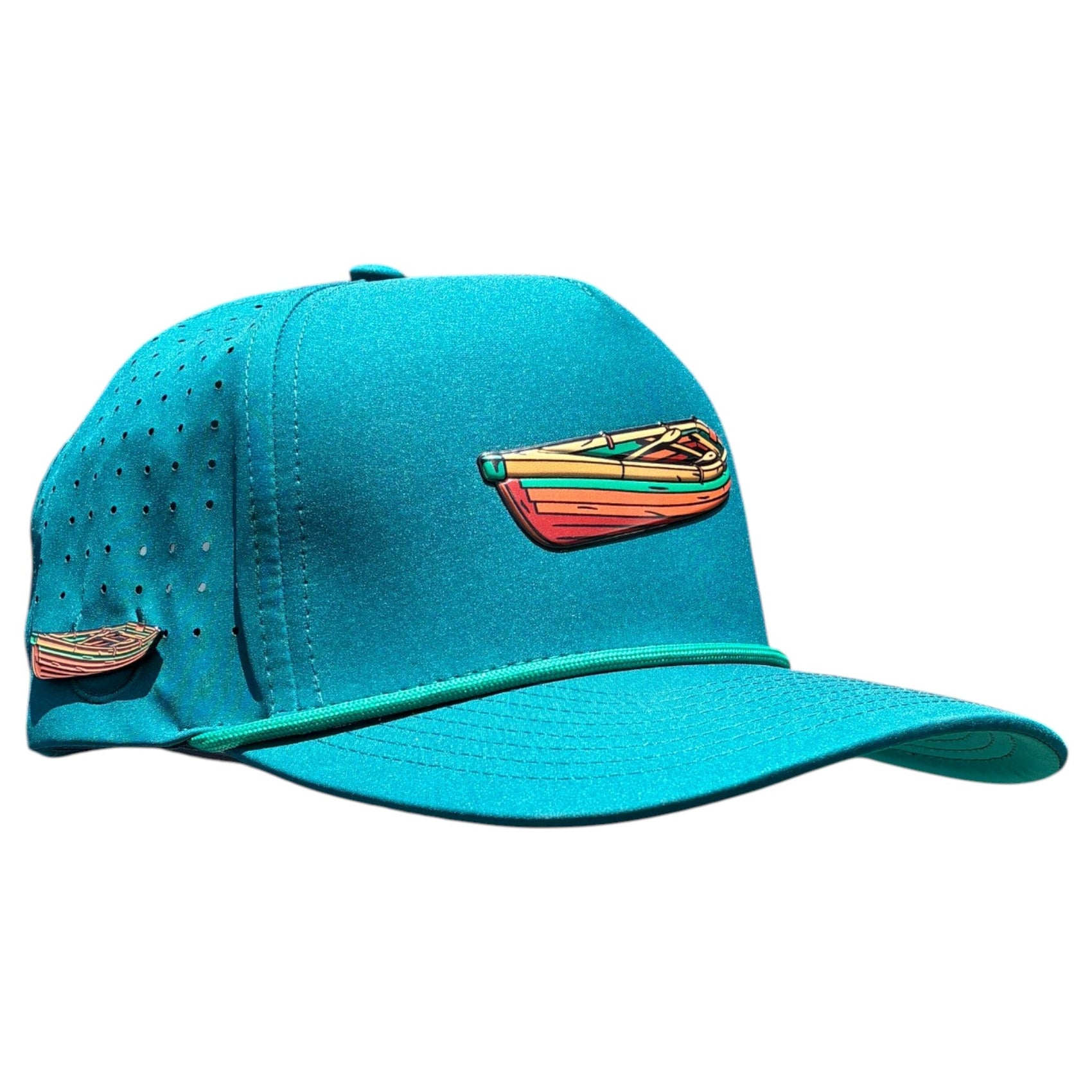 The Logie Joe's Golf Driftwood Golf Hat in Wood Boat Teal features perforated side panels, colorful embroidered canoe designs, and an adjustable snapback with a built-in magnetic ball marker holder plus marker.