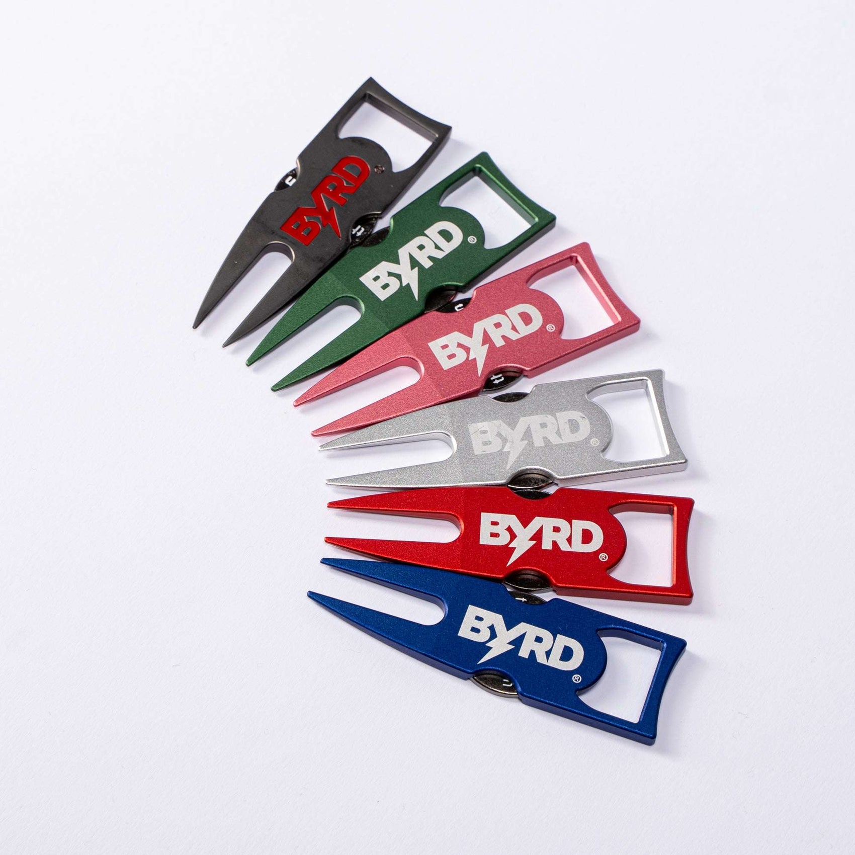 Five BYRD DIVOT TOOL - 4 in 1 by The Byrd, LLC—each features a ball marker holder—in black, green, pink, silver, and blue displayed fan-shaped on a white background.
