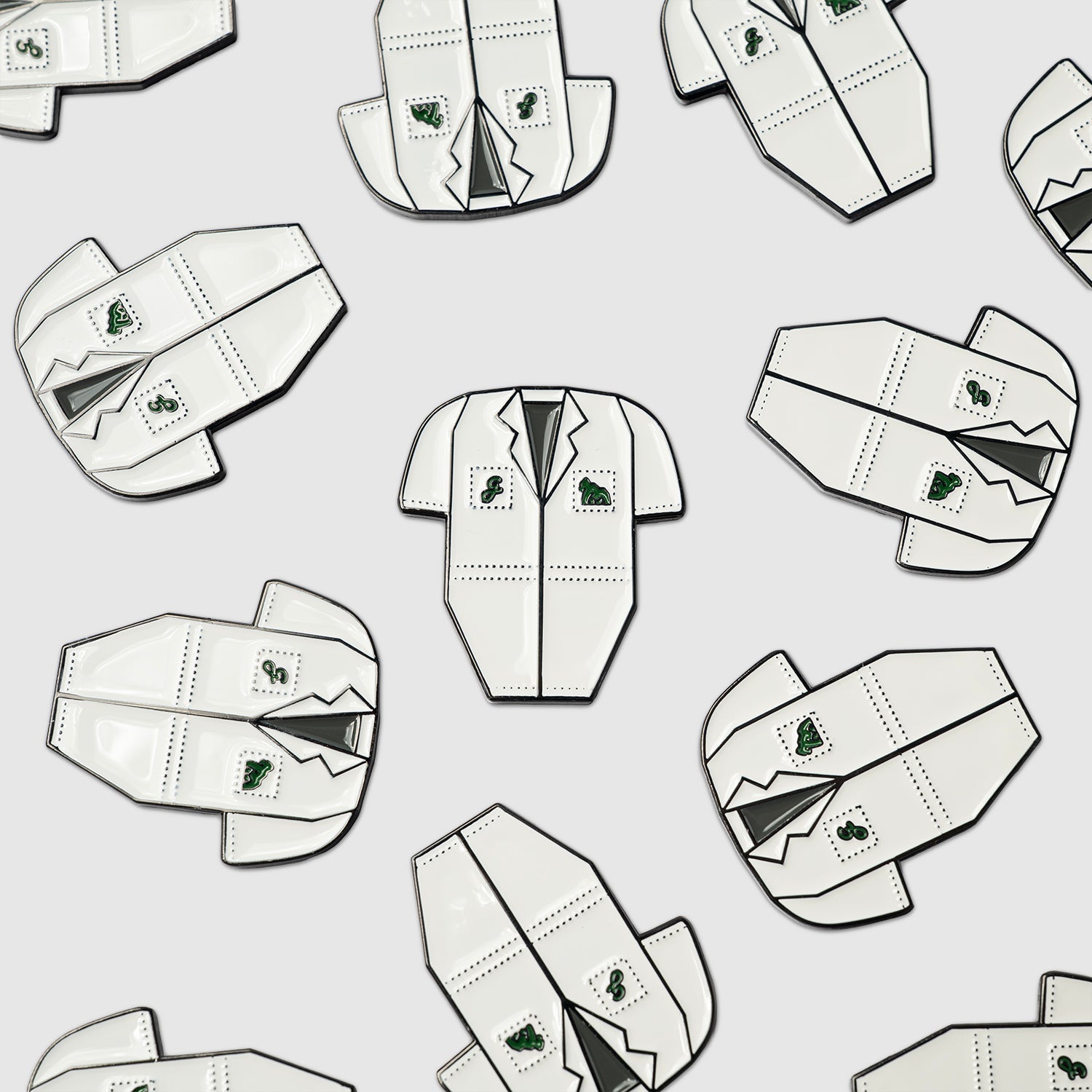 Pattern of white Guerrilla Golf Caddy Bib Ball Markers shaped like lab coats, with green patches and pocket details—each designed as a novelty marker—arranged evenly on a light gray background.