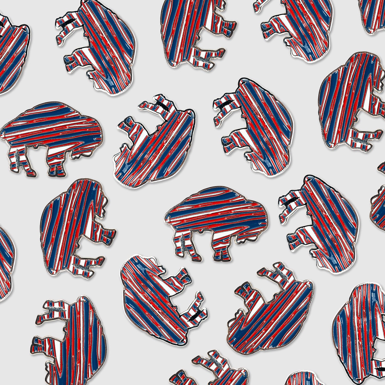 Guerrilla Golf’s RWB Buffalo Ball Marker pins, featuring bold red, white, and blue stripes in a distinctive bison shape, are displayed in a repeating pattern on a white background—ideal for showcasing your team pride or adding a unique touch to your golf accessories.